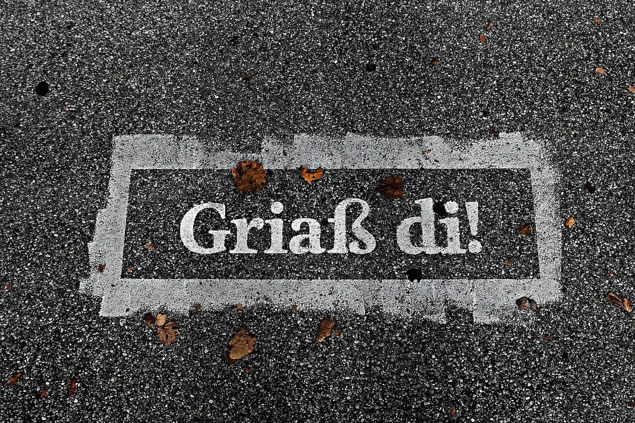 Griaß di: bairischer Gruß als Schriftzug auf dem Asphalt
